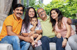 © GAJENDRRA BHATI  - Portrait of Happy indian family sitting together at home looking at camera, togetherness and bonding.