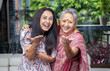 © GAJENDRRA BHATI  - Portrait of cheerful crazy indian mother and daughter looking at camera with hand gesture at home, Love and bonding, Asian family.