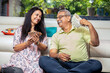 © GAJENDRRA BHATI  - Happy mature senior Indian couple holding money rupee notes in hand while sitting at home. Savings and banking concept