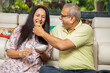 © GAJENDRRA BHATI  - Happy senior indian couple eating pani puri dish together at home. 60s Retired husband wife spend time with each other and eating food having fun. Retirement life.