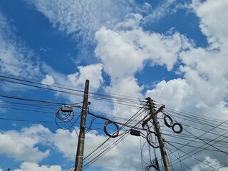 Many electrical cables with brightly colored sky are very beautiful.