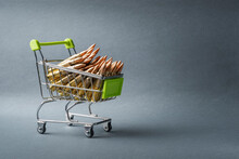 Rifle Cartridges In A Shopping Cart. 223 Caliber Ammo Cartridges And A Small Shopping Basket. Copy Space