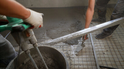 Poster - Workers pour self-leveling floor. Pouring Self-Leveling Floors. Self-Leveling Floors On A Large Area, A Worker. Self-leveling epoxy. Leveling with a mixture of cement floors.