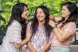 © GAJENDRRA BHATI  - Three Happy indian women standing together at home. Mother with two young daughters having fun laughing. Closeup
