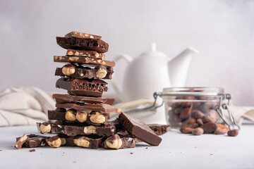 Wall Mural - Pieces of chocolate bars with nuts for tasty break or as ingredient for cooking