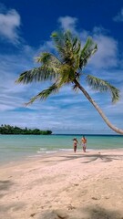 Wall Mural - couple on a tropical beach during vacation at the Island of Koh Kood in Thailand, men and women on a white beach 