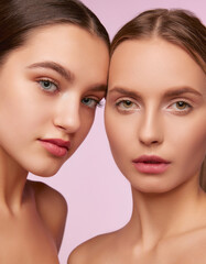 Perfection. Portrait of two young, beautiful girls with well-kept fresh skin isolated over pink studio background. Concept of skincare, cosmetology, natural beauty