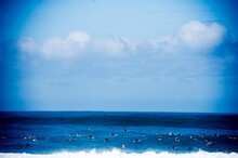 A Crowded Surfer Lineup Fills The Hawaiian Shoreline