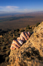 A Detail Shot Of A Man Topping Out While Bouldering In A High Desert Valley.