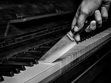 Knife Cutting A Piano Like A Cake