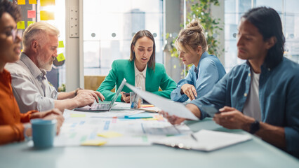 Poster - Colleagues Sit Behind Conference Table at the Office and Discuss Business Development, Sales Analysis and Design. They are Using Charts and Statistics, Laptop Computer, Tablet, Smartphone
