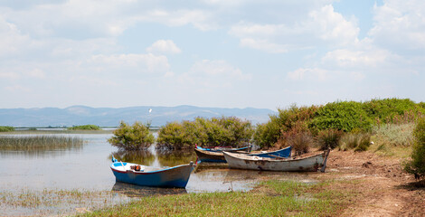 Wall Mural - Marmara Lake with lone sandal (boat) - Manisa, Turkey - Beautiful landscape with amazing cloudy sky 