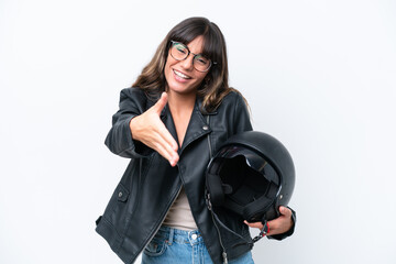 Wall Mural - Young caucasian woman with a motorcycle helmet isolated on white background shaking hands for closing a good deal