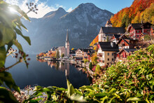 Impressive View Of Famous Old Town Hallstatt, Salzkammergut, Austria. Scenic Golden Morning Light On A Beautiful Sunny Day At Sunrise In Summer. Concept Ideal Resting Place. Popular Travel Destination