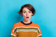 Portrait of astonished impressed woman with short hairdo wear orange sweater staring at discount isolated on blue color background