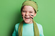 © ADDICTIVE STOCK - Happy girl with stripes on cheeks looking at camera