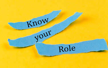KNOW YOUR ROLE text on a blue pieces of paper on yellow background, business concept