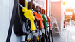 © kanpisut - Petrol pump filling fuel nozzle in gas station. Fuel Pump, Gas Station, Gasoline. Colorful Petrol pump filling nozzles