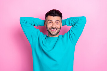 Wall Mural - Photo of young positive wearing blue sweatshirt man chilling take nap pause break after hard work days hands head isolated on pink color background
