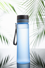 Sticker - Stylish thermo bottle on mirror table against white background