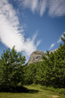 Beautiful summer mountain peak framed by wispy clouds