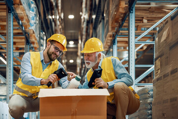 Wall Mural - Warehouse workers  scanning barcodes on boxes in warehouse