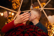 © verona_studio - Young couple is getting engaged. Romantic couples after proposal moment with a big bouquet of red roses