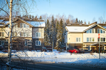 Wall Mural - Modern village house in winter day and trees near it in snow in sunny day