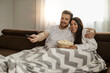 © ivanko80 - Young couple watching TV at home