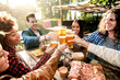 canvas print picture - Young multiracial people drinking beer at brewery bar out doors - Happy family having barbecue party in backyard restaurant patio - Concept about friends enjoying time  together - Focus on pint glass