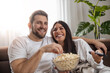 © ivanko80 - Young couple watching TV at home