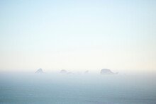 Morning Fog Settles Around Rock Formations Near The Shore Of The Pacific Coast In Southern Oregon