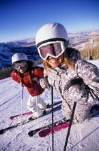 Two Women In Helmets On The Ski Slopes In Utah.
