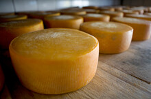 Cheese Wheels Age On Wood Racks