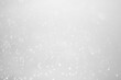 © niwat - White glitter vintage lights background.  White bokeh shiny on dark background.