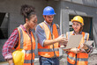 © Chalermphon - Engineering project manager with team civil engineer multiethnic teaching plan using laptop. Multiracials worker cheerful happy working in construction site. Gender equality concept.