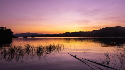 Wall Mural - landscape sunset with Reservoir and raft house Thailand