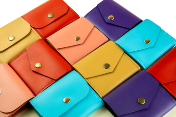 Wall Mural - bright colored leather wallets lie tightly to each other. close-up on a white background