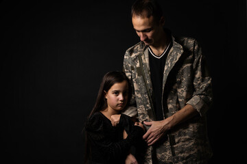 Wall Mural - military man and daughter on a black background