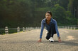 © Prathankarnpap - Sporty woman in starting position, ready to run outdoors. Make effort for victory, Fitness, sport and healthy lifestyle concept