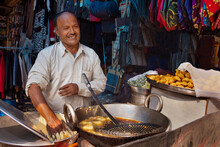Male Vendor Making Aloo Vonda At His Roadside Food Stall