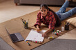 © IndiaPix - Top angle view of a girl drawing while lying down on carpet in living room