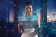 © IndiaPix - Young woman uses digital tablet on virtual visual screen at night