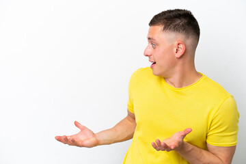 Young brazilian man isolated on white background with surprise expression while looking side