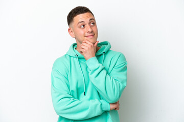 Young brazilian man isolated on white background thinking an idea while looking up