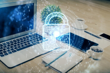 Poster - Double exposure of desktop with computer and lock icon hologram. Concept of data safety.