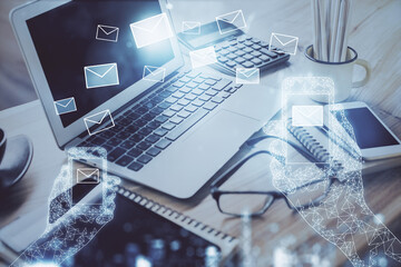 Poster - Desktop computer background in office and flying envelops hologram drawing. Double exposure. Electronic mail concept.