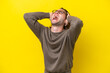 Caucasian handsome man isolated on yellow background stressed overwhelmed