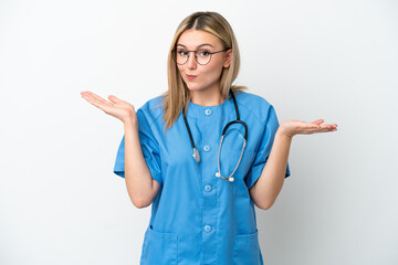 Young surgeon doctor woman isolated on white background having doubts while raising hands