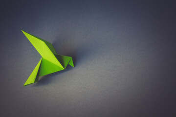 Wall Mural - green paper dove origami isolated on a grey background